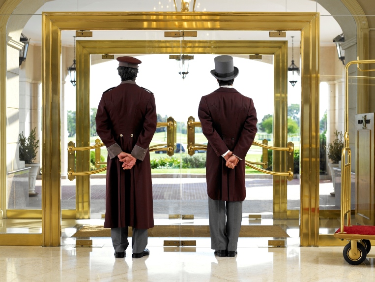 bellhops standing at hotel doors