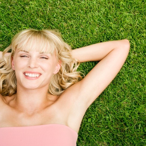 woman smiling lying in grass
