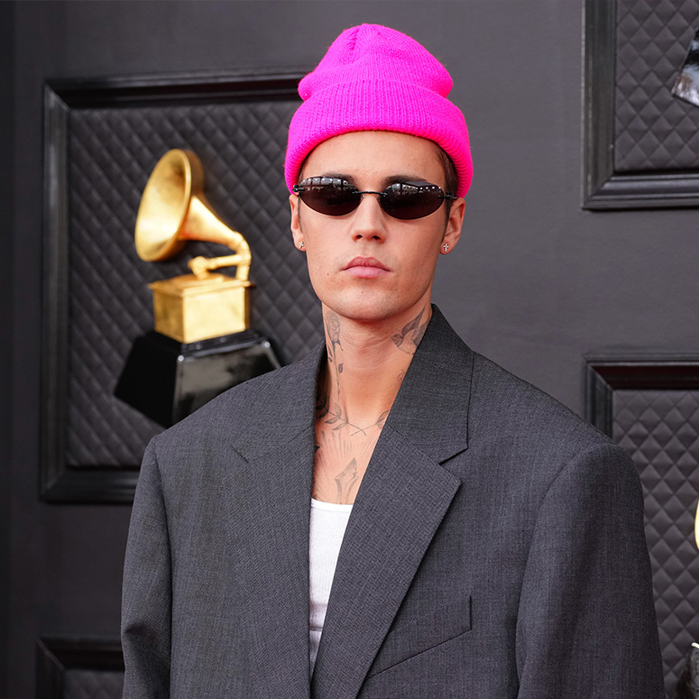 Justin Bieber wearing a pink hat and sunglasses at the Grammy's