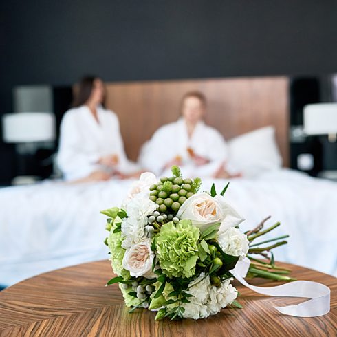 Couple in hotel room bed after wedding