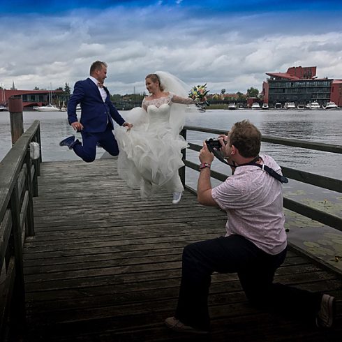 Photographer snapping bride and groom