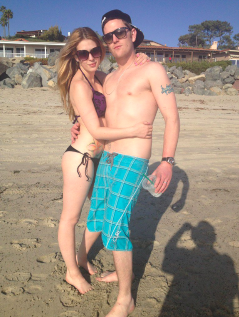 Josh poses on the beach with a woman
