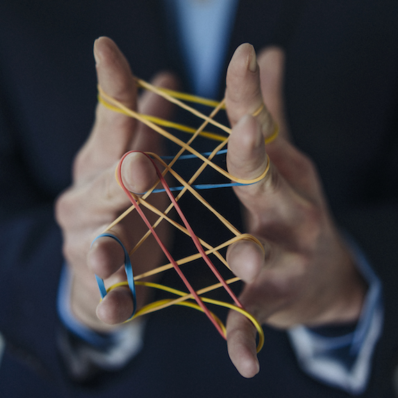 Hands holding a variety of rubber bands