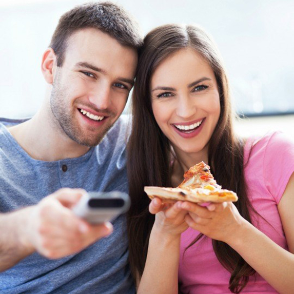 Couple eating in front of the television