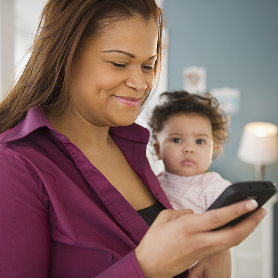 young mother looking at her cell phone