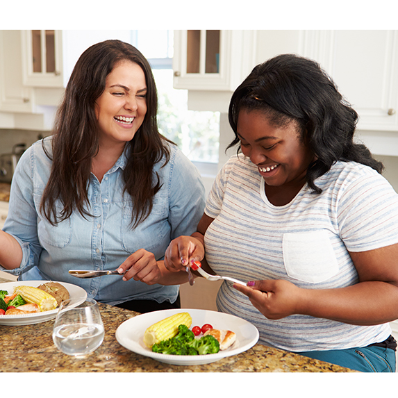 Two Overweight Women Eating Healthy Meal