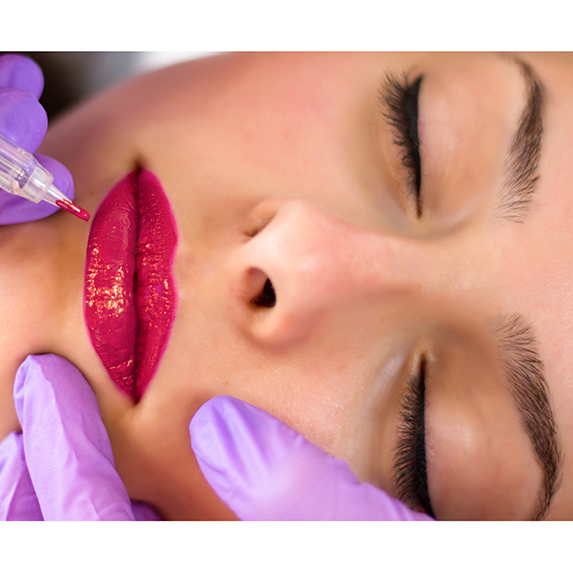 woman applying permanent lip colour