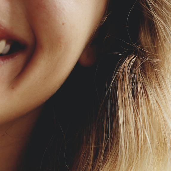 Close-up shot of woman's smiling cheeks