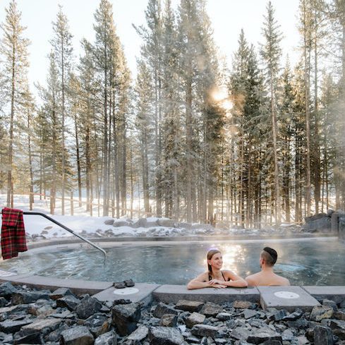 Couple enjoys the outdoor Nordic spa facilities at Lodge at Kananaskis