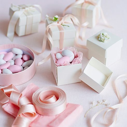 A closeup of wedding favours in boxes with bows
