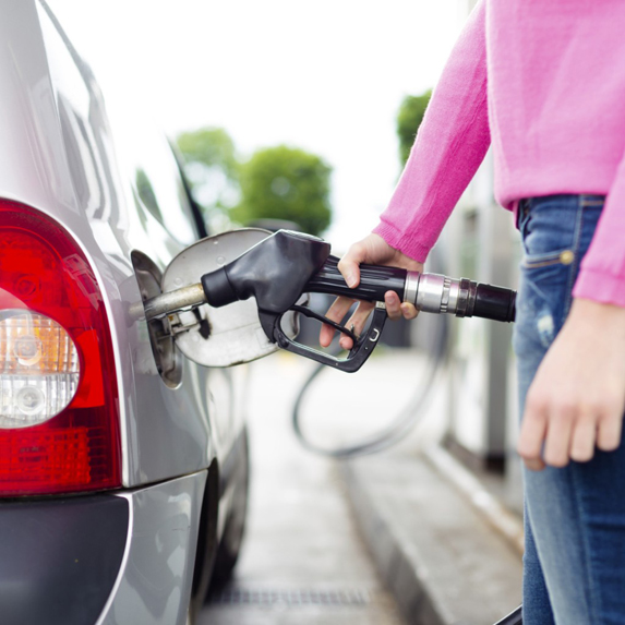 Women pumping gas in car