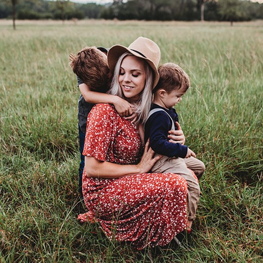 Woman with kids in a field