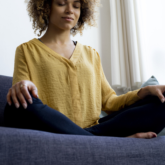 Woman meditating on couch