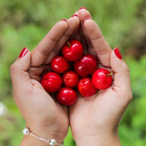 Woman holding cherries