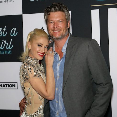 Blake Shelton and Gwen Stefani at an event, smiling for the cameras