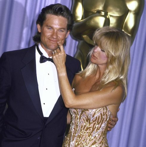 Goldie Hawn pinching Kurt Russell during an Academy Awards ceremony