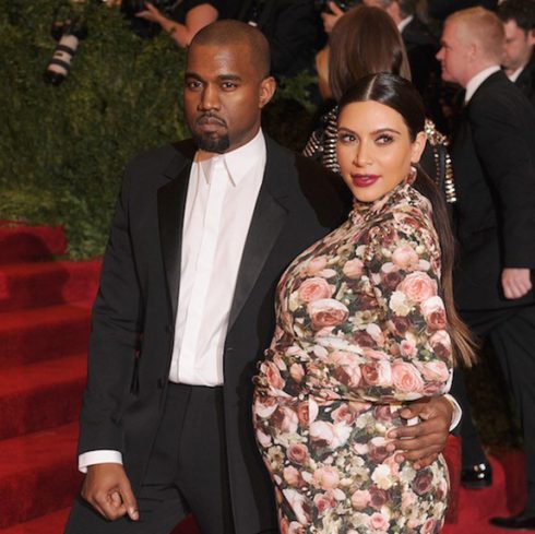Kanye West with a pregnant Kim Kardashian at a formal event