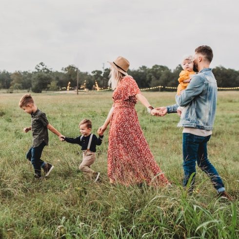 Family walking in a field together