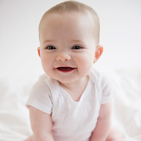Smiling baby girl looking off-camera