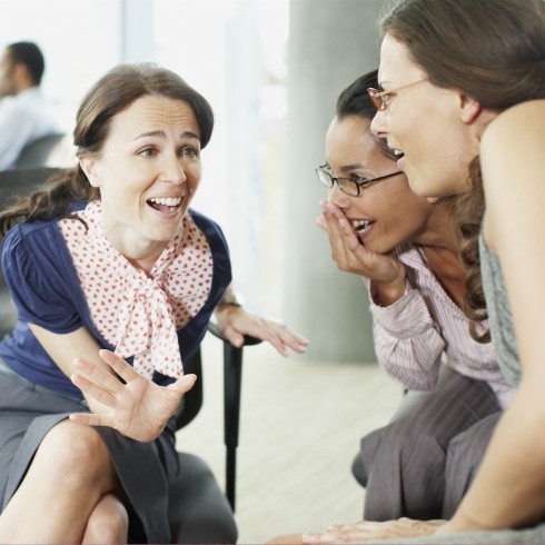Three women gossiping at work