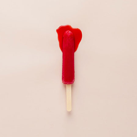A red dripping popsicle as a metaphor for periods
