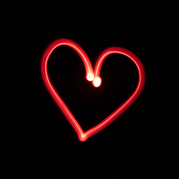 A drawn red heart on a black background