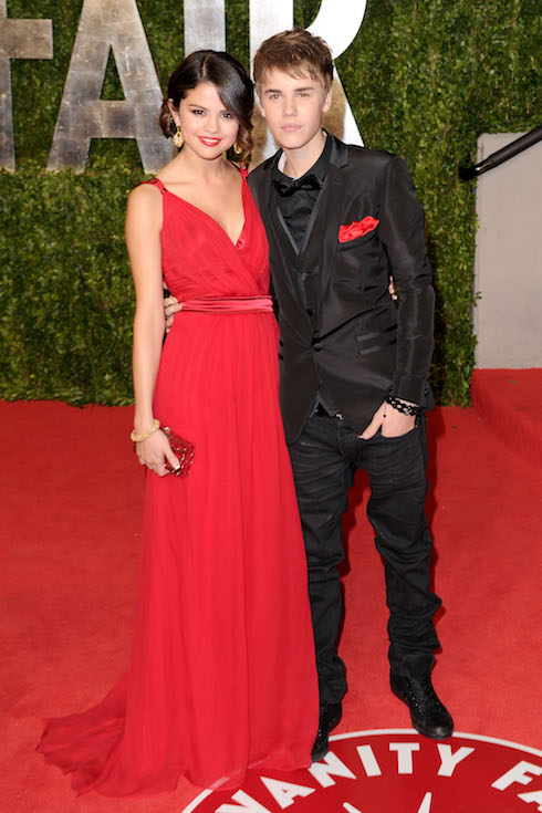 Selena Gomez and then-boyfriend Justin Bieber pose at the 2011 Vanity Fair Oscar Party