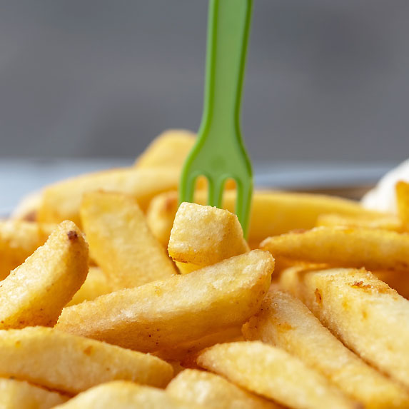 French fries picked up by green fork