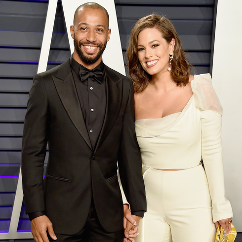 Ashley Graham and Justin Ervin holding hands at a red carpet event