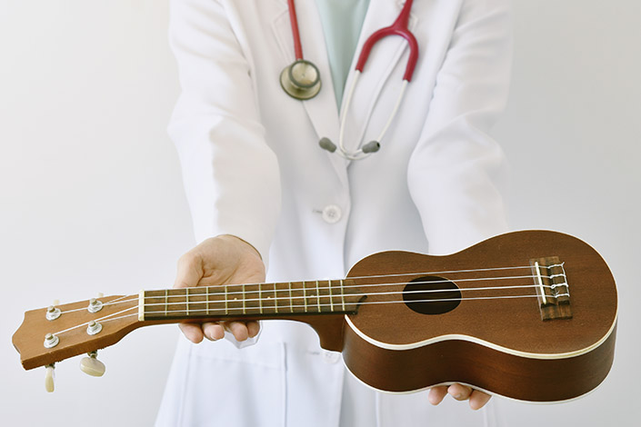 Doctor offering a ukulele to you