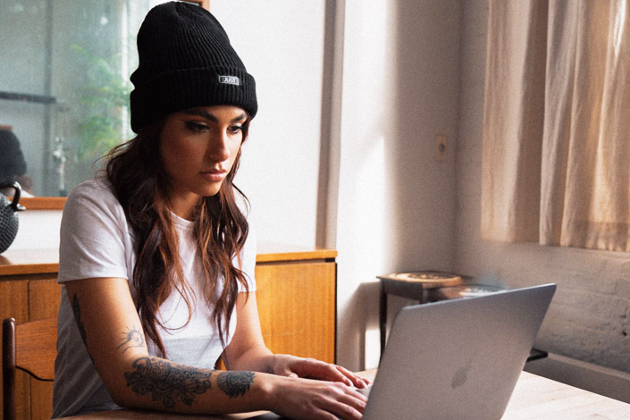 Woman in a beanie working from home