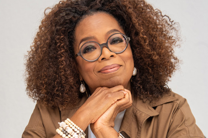 Oprah resting her head on her hands
