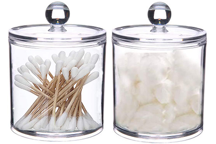 two clear glass jars, one with cotton balls, one with q-tips