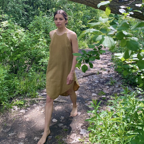 woman in forest with moss green knee length dress