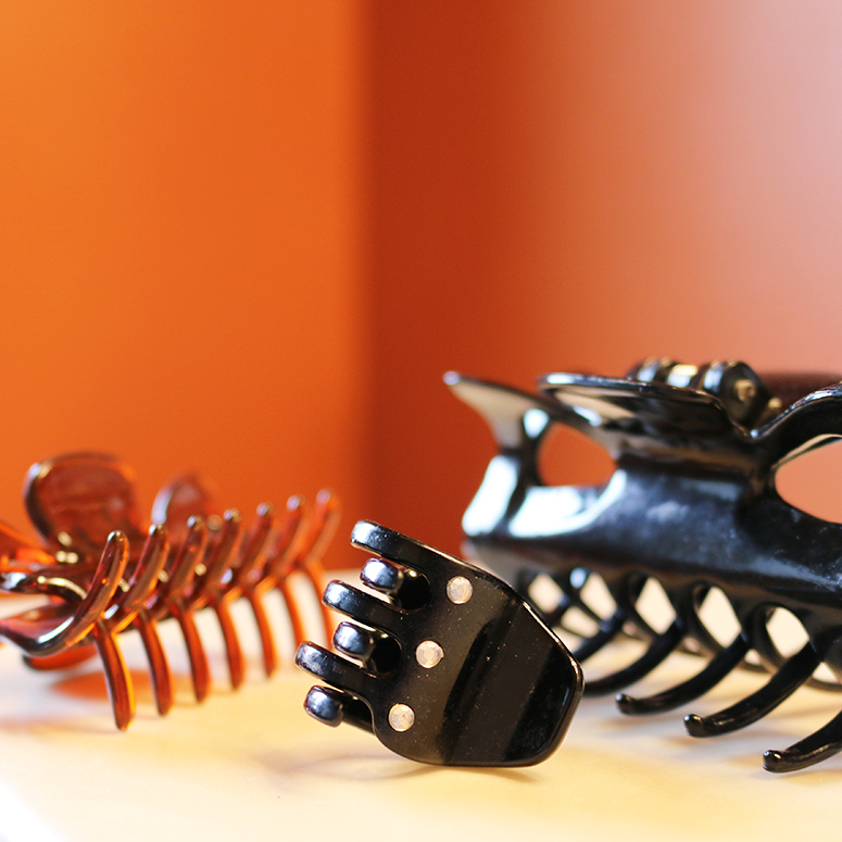 a variety of claw clips, in different sizes, on a nightstand