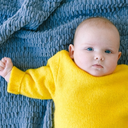 Baby in a yellow sweater.