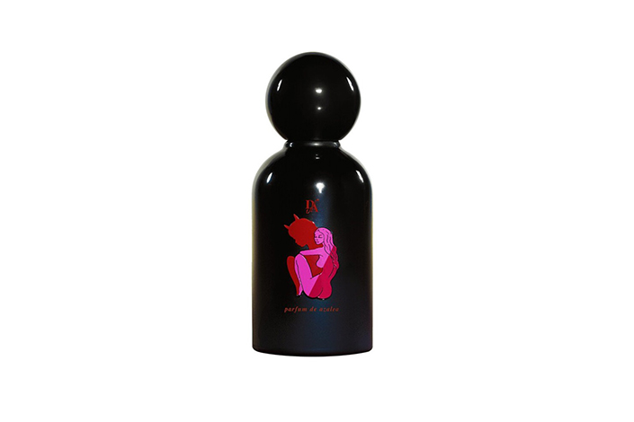a small black bottle of perfume with hot pink artwork