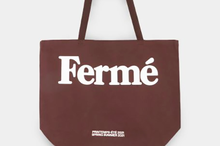 a brown tote bag with Ferme written on the front in white