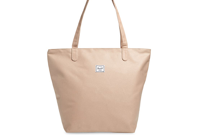 a pale pink tote bag against a white background