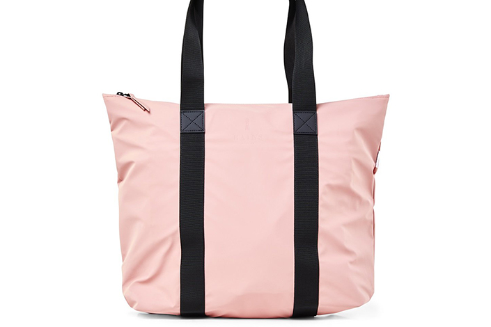 a hot pink tote bag with black straps against a white background