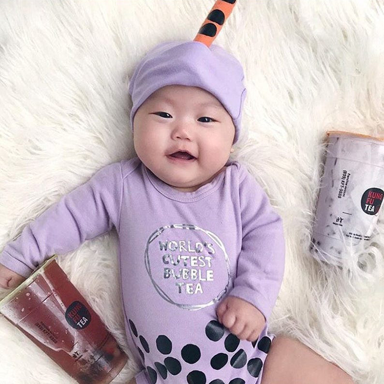 a tiny Asian baby wearing a bubble tea costume