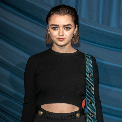 Maisie Williams wearing a black long sleeve fitted crop top