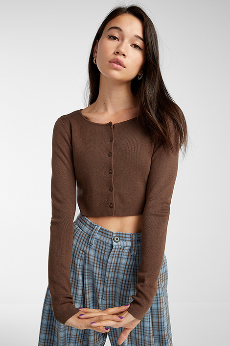 a young Asian woman in a brown cropped cardigan sweater