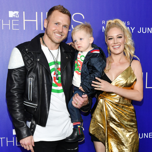 Spencer and Heidi Pratt with their son Gunner. Heidi wears a shiny gold dress while Spencer is seen in a white tee and leather jacket