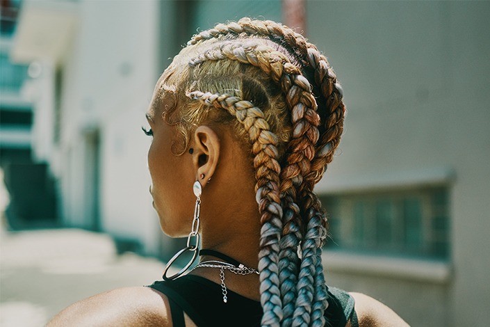 Woman with long, colourful cornrows