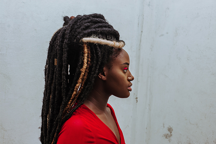 Woman with dreadlocks on top of her head