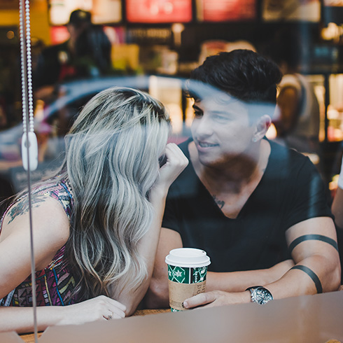 Woman looking at male inside a Starbucks