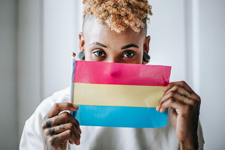 Woman holding the pansexual pride flag