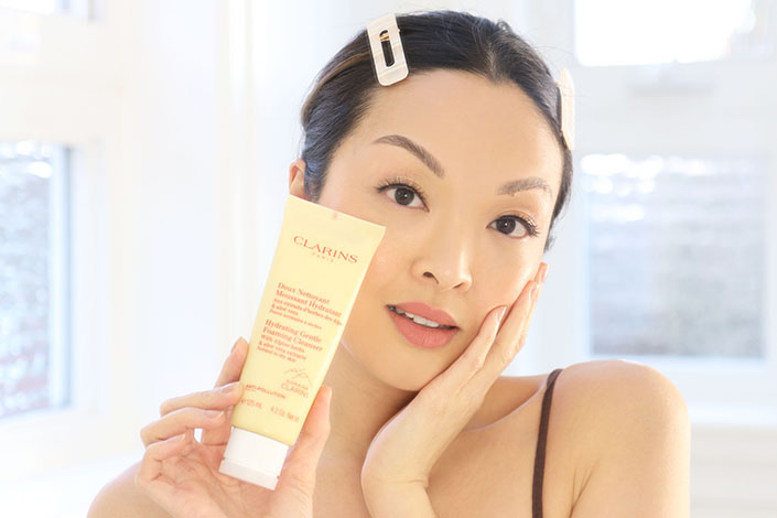 Jennifer Chiu poses with a Clarins product