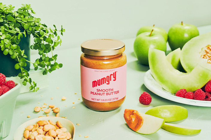 Mumgry Smooth Peanut Butter with apples and peanuts beside it